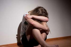 Woman huddled up on the floor